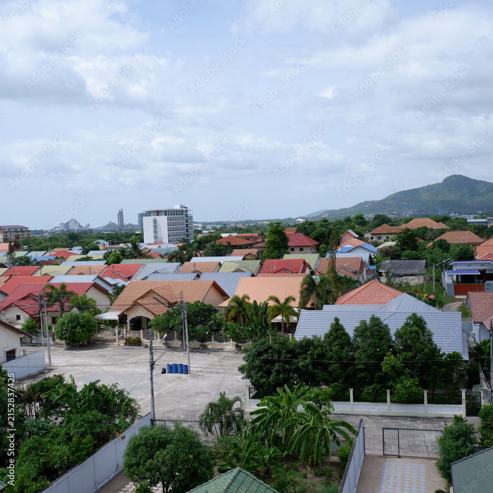 Fototapeta premium Panoramic Aerial View of Suburban Village Homes with Mountain Backdrop