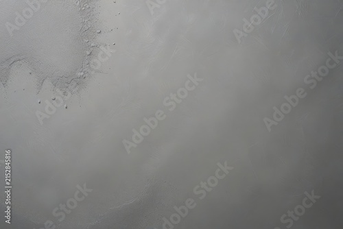 Close-up of textured gray surface with subtle tonal variations, rough patches, and faint scratches, highlighting natural imperfections and monochromatic detail.