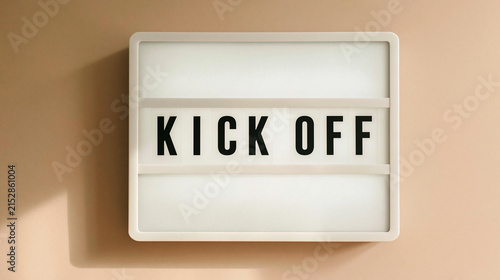 Kick Off Announcement: A modern light-up sign displays the prominent words KICK OFF, signaling the start of a new project, event, or campaign, set against a soft, neutral background.