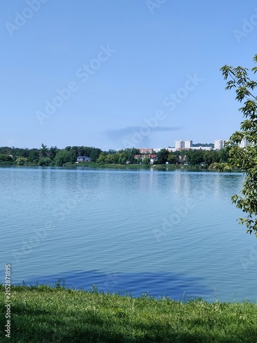 A large lake and buildings in the background, a plume of smoke from a fire following a Russian attack on Kharkiv, the war in Ukraine.