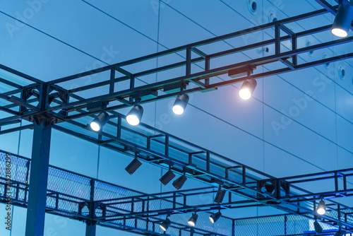 Directional LED lights on rails under the ceiling in a modern warehouse, shopping center building, office or other commercial real estate object.