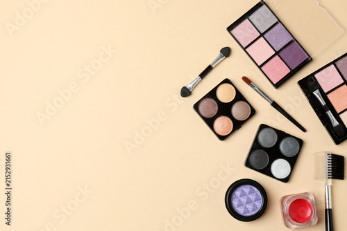 Obraz na płótnie Cosmetics and makeup brushes on a beige background, essential beauty and skincare products, flat lay composition