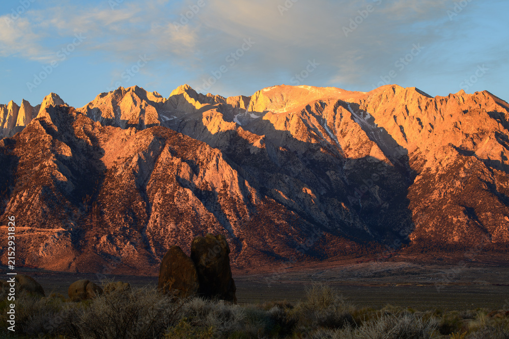 Fototapeta premium Majestic sierra nevada mountain peak glows with golden sunrise light evoking awe and serene natural majesty during peaceful morning landscape view