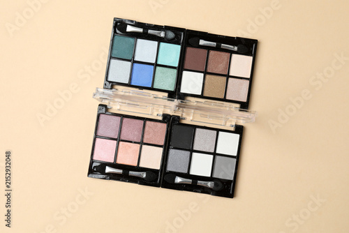 Canvas Print Cosmetics and makeup brushes on a beige background, essential beauty and skincare products, flat lay composition