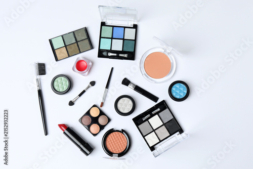Fotografie Cosmetics and makeup brushes on a white background, essential beauty and skincare products, flat lay composition