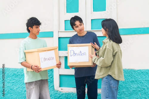 Young volunteers collecting donation boxes for charity work