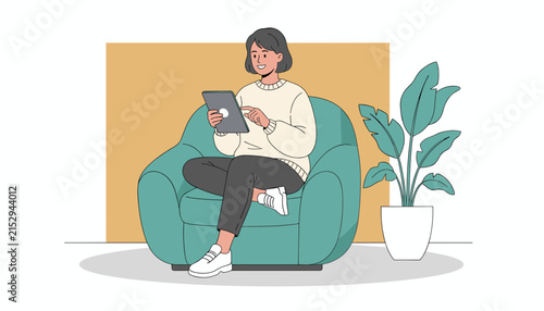 Young woman sitting comfortably in a teal armchair while browsing on her digital tablet in a modern home interior setting.