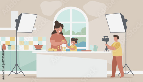Mother and her young daughter cooking together in a kitchen studio while being filmed by a professional cameraman.
