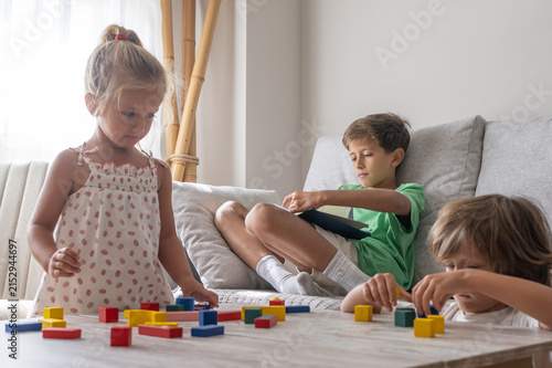 Bild auf Leinwand Children are engaging in creative play and learning, with a young girl building