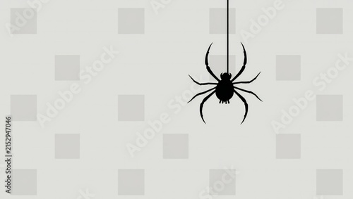 A small black spider hanging from a silk thread on a light grey background with a pattern of squares