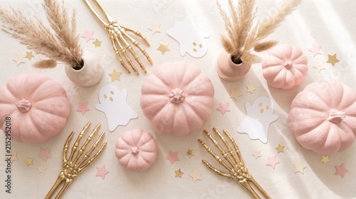 Pastel Halloween Flat Lay, Pink Pumpkins, Gold Skeleton Hands, Ghost Decorations, Star Confetti. copy space.