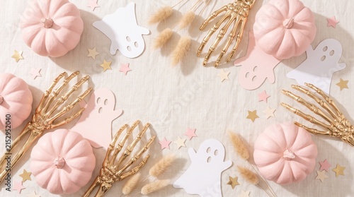 Pastel Halloween Flat Lay, Pink Pumpkins, Gold Skeleton Hands, Ghost Decorations, Star Confetti. copy space.