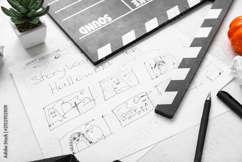 Принти на полотні Clapperboard with storyboard and different Halloween decor on white background