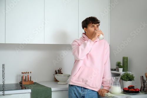 Young man drinking fresh mi...