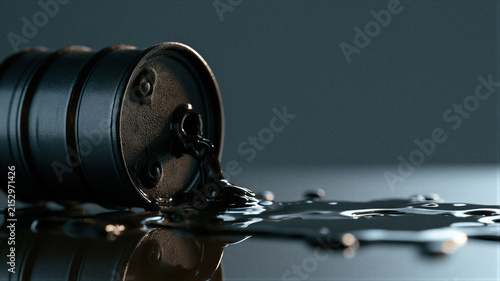 Black oil leaking from metal drum on dark floor. Financial crisis and global market crash concept. Energy industry economic downturn, resource depletion and environmental disaster.