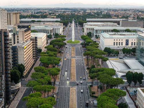 Aerial view of the EUR district featuring the iconic obelisk, wide boulevards lined with pine trees, and rationalist architecture in Rome, Lazio, Italy.