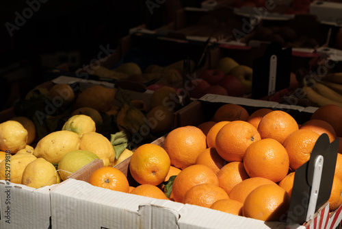 Fresh citrus fruits, oranges and lemons on a market stall