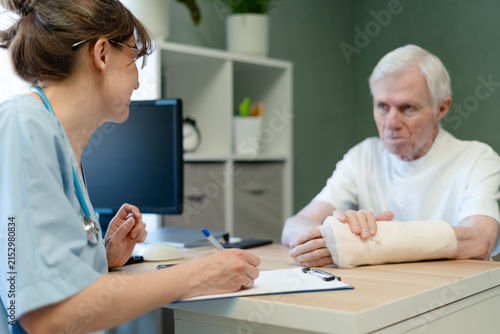 Photography Doctor discussing treatment plan with senior patient in office