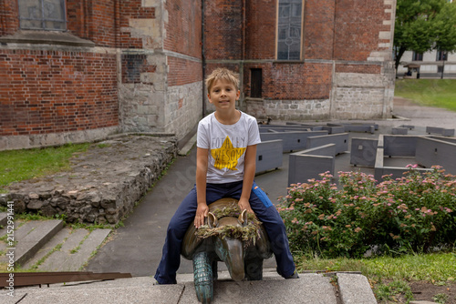 Quadro su tela Cute preschool child, boy walking along colorful cobblestone streets of Riga