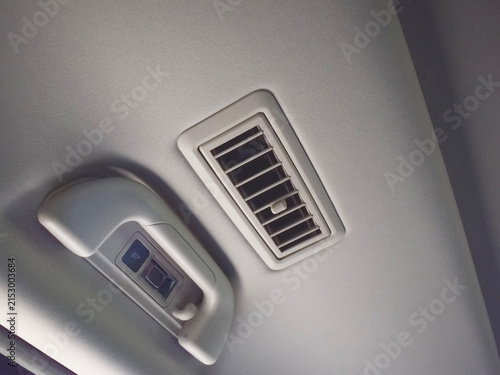 Fotografía Close-up view of a modern car interior ceiling featuring an air conditioning ven