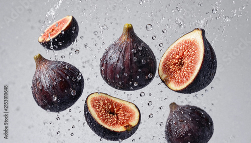 Photography Fresh dark purple figs falling through the air with water splashes and droplets