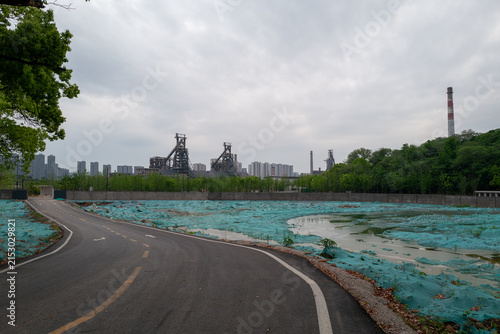 Urban Industrial Park with Smokestacks and Cordoned Land


