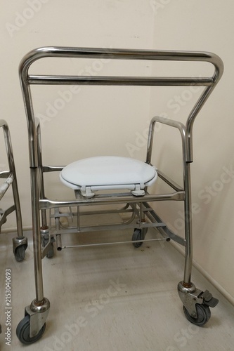 a stainless steel commode chair designed for mobility assistance and hygiene support