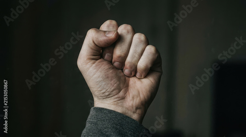 Clenched fist symbolizes strength and resilience in workforce while highlighting importance of mental health awareness and support