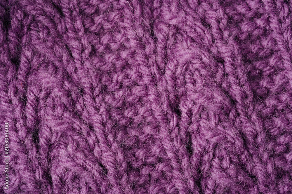 Fototapeta premium Purple knitted fabric close up with cable knit pattern