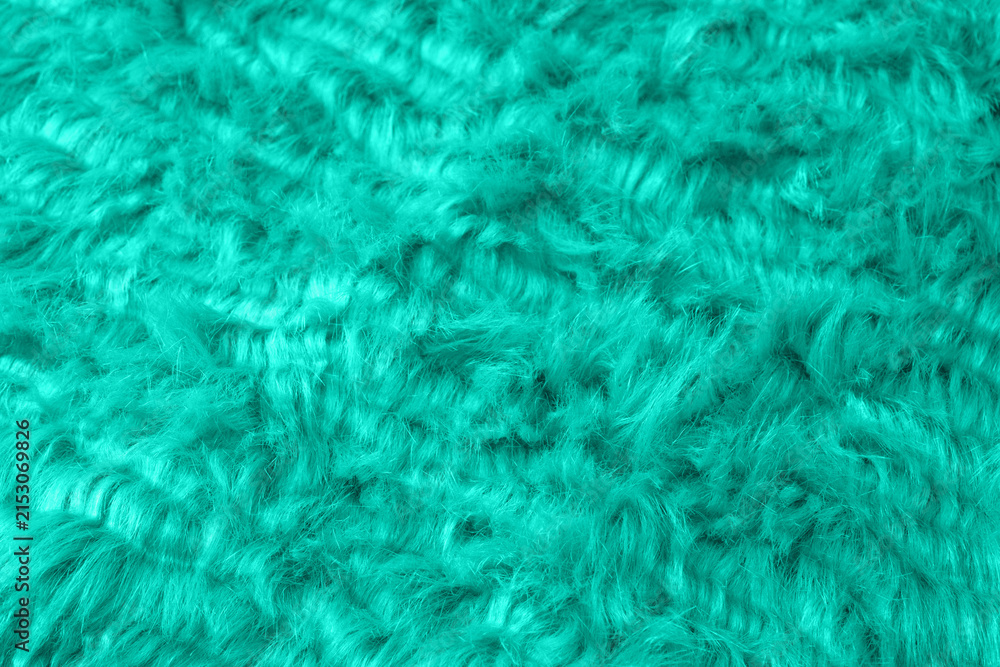 Obraz premium Close up view of vibrant teal fuzzy plush fabric background texture showcasing soft shaggy material detail