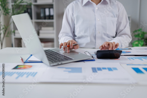 Business woman analysis summary graph reports of business operating expenses and work data about the company's financial statements.