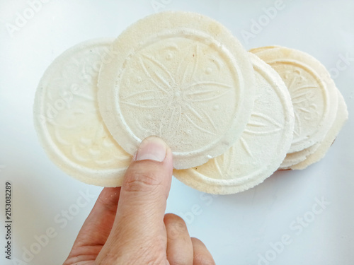 Hand holding a Simping kencur, traditional Indonesian snack and cracker from Sunda