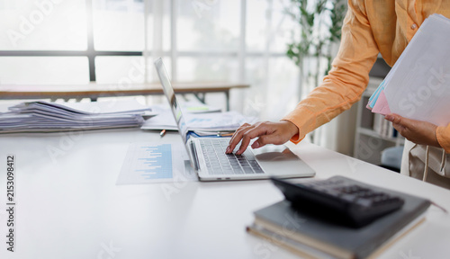 Document management. Businesswoman working with stack of paper files for searching and checking corporate files, document achieves on folders paper on office 