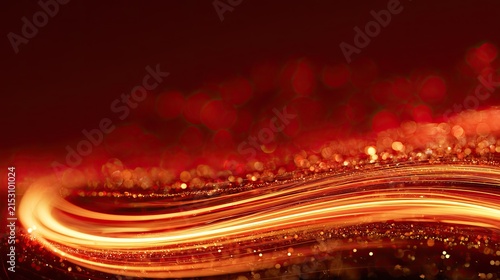 Fiery golden light trails and sparkling particles on a deep red background