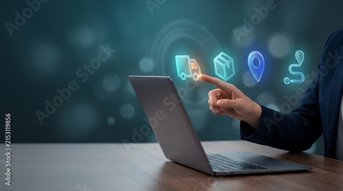A business person using a laptop and interacting with digital holographic currency icons to manage global online financial investments