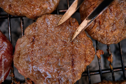 Juicy Burgers Grilling on Outdoor Charcoal BBQ