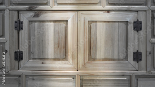 Antique Metal Hinges and Square Raised Panel Design on Natural Wood Cabinet Door