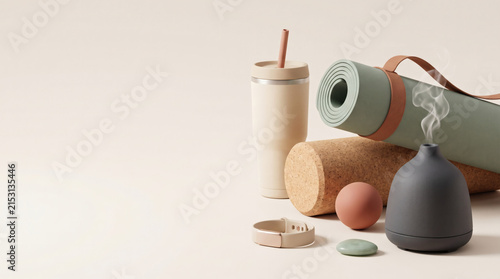 3D rendered yoga and wellness equipment with mat, diffuser and cork roller on beige background with copy space.