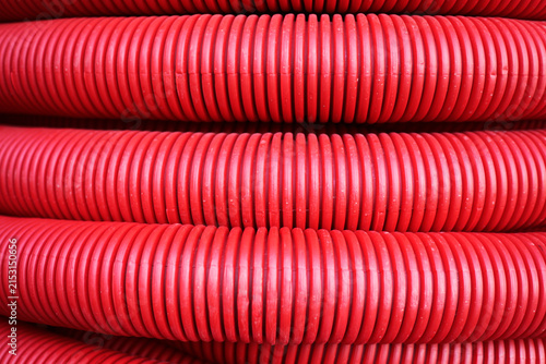 Close-up of red corrugated plastic pipe coils