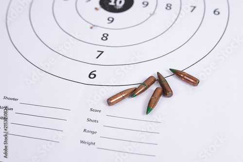 Fotografie High Angle of Rifle Bullets Placed on Paper Target with Score Card Fields