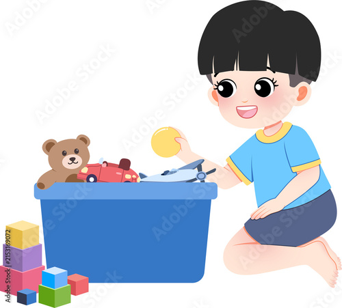 Young boy organizing toys in blue storage box with teddy bear car and building blocks