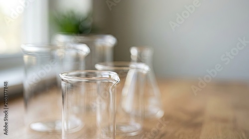 Laboratory Glassware Beakers and Flasks on Wooden Table