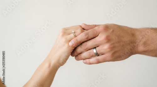 Close Up of Married Couple Holding Hands With Wedding and Engagement Rings