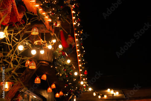 Decorative lights hang on walls during a night Christmas celebration in a festive area