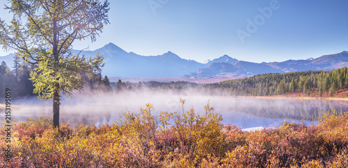 Mountain lake on a foggy morning, autumn landscape, forest banks