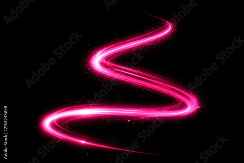 Abstract pink light trail with glowing particles on black background