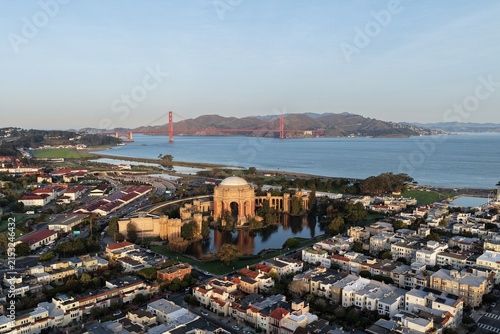 Aerial view of San Francisco's Palace of Fine Arts near the Golden Gate Bridge at golden hour. g.