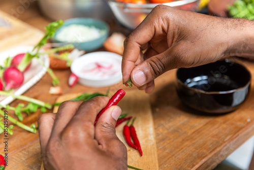Bild auf Leinwand Hands preparing fresh red chilies
