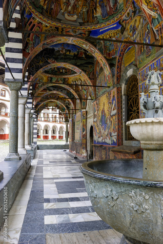 Bild auf Leinwand The Rila Monastery in Bulgaria, a UNESCO World Heritage site, features stunning frescoes adorning its cloister walkways, depicting religious scenes and figures