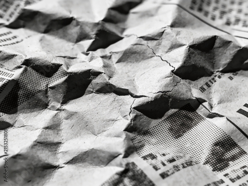 High-resolution professional stock photo of monochrome crumpled paper texture with vintage halftone dot print pattern.